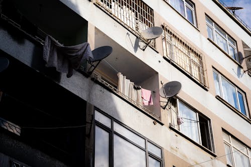 Satellite Dish Mounted on Apartment Building Balconies