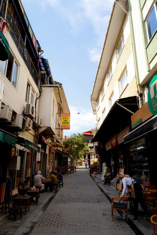 Free Charming urban alleyway lined with restaurants and cafes, a vibrant community scene. Stock Photo