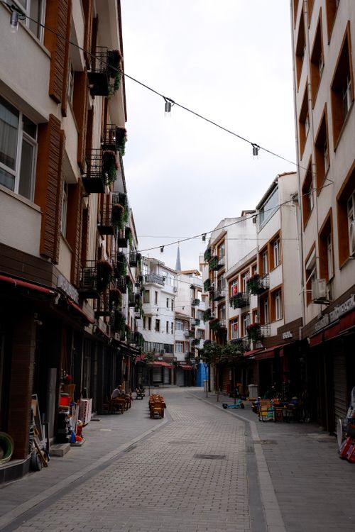 Free A charming narrow street lined with buildings in an urban setting. Ideal for cityscape visuals. Stock Photo