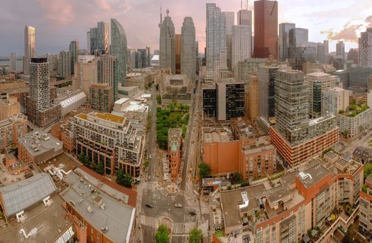 Skyline of a modern city captured from above, showcasing skyscrapers and urban streets.