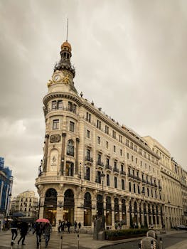 View of a historic building with clock tower in Madrid, ideal for travel and architecture themes.