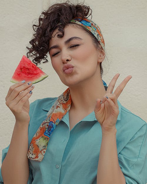 Woman in Blue Shirt Holding Watermelon