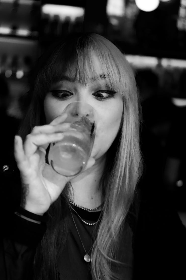 Woman Drinking Cocktail In Glass