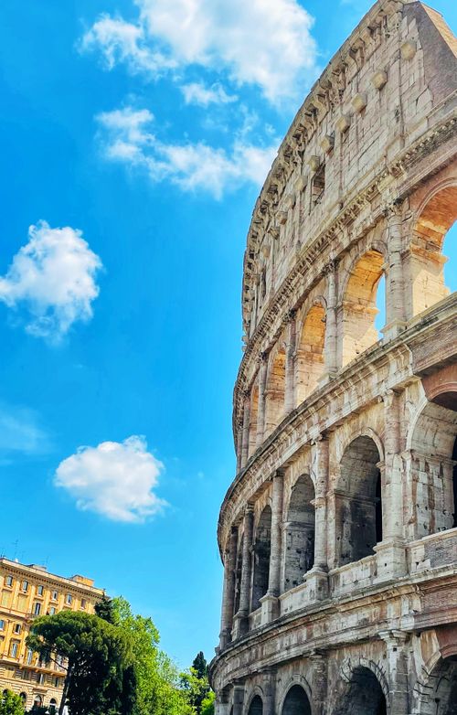 Free Stunning view of the historic Colosseum in Rome with a vibrant blue sky backdrop. Stock Photo