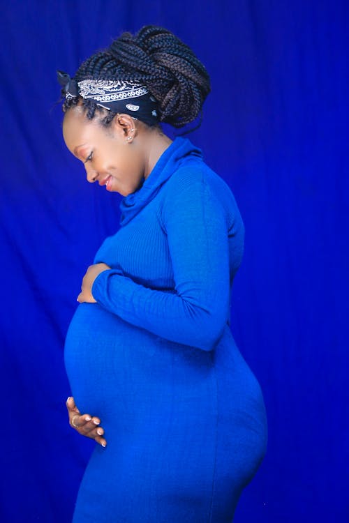 Pregnant Woman in Blue Long Sleeve Dress