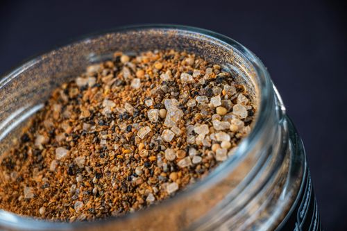Free A detailed close-up of a spice mix in a glass jar, showcasing texture and color. Stock Photo