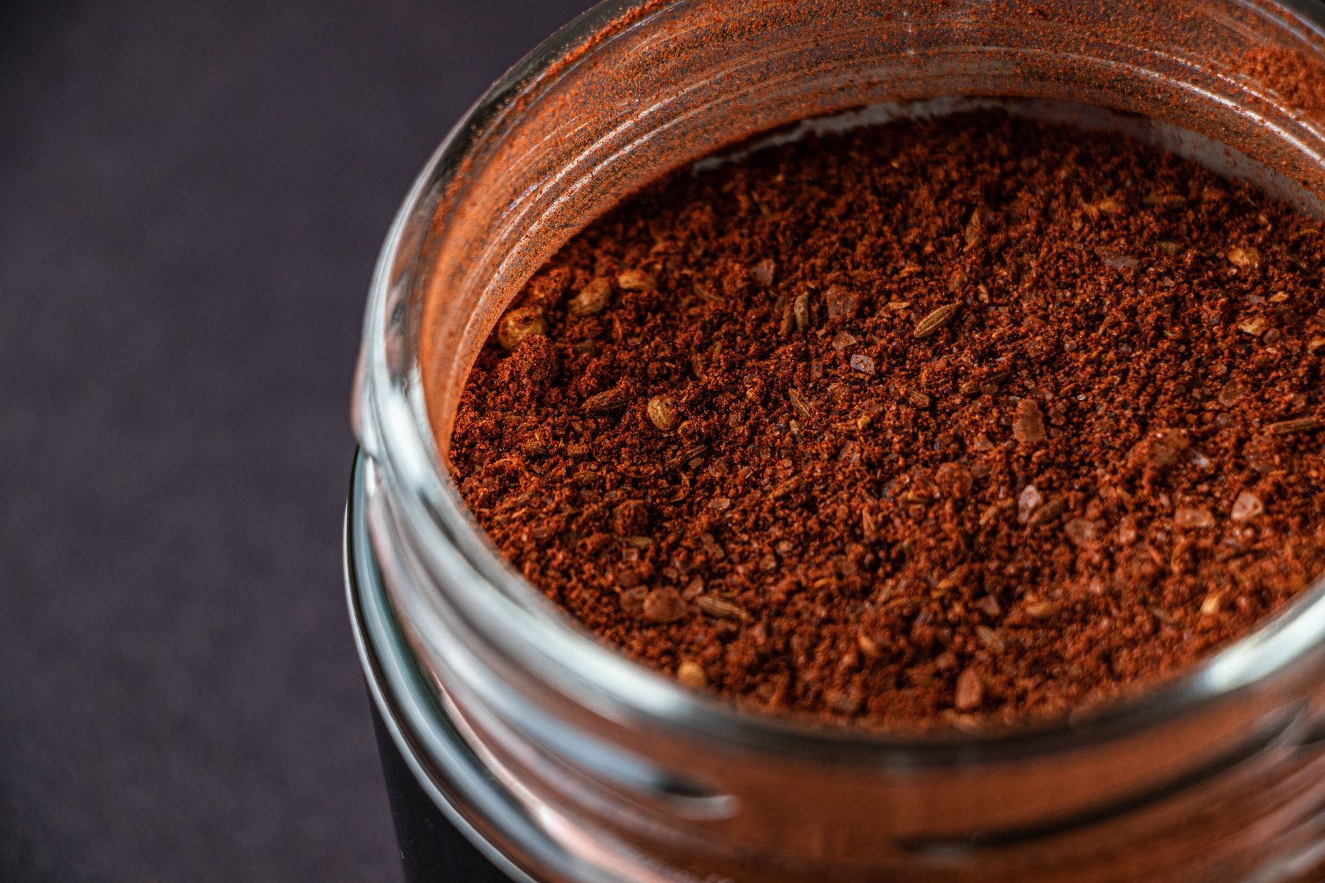 Airtight glass jars storing dried herb seasoning blends