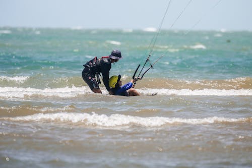 Man in Wetsuit Tries Kiteboarding