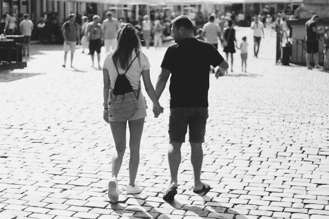 Man and Woman Holding Hands While Walking · Free Stock Photo
