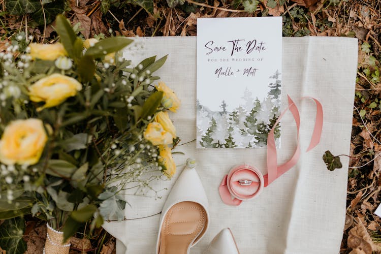 A Wedding Card Near Yellow Flowers