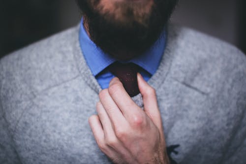 Free Man Wearing Gray Top Fixing Red Necktie Stock Photo