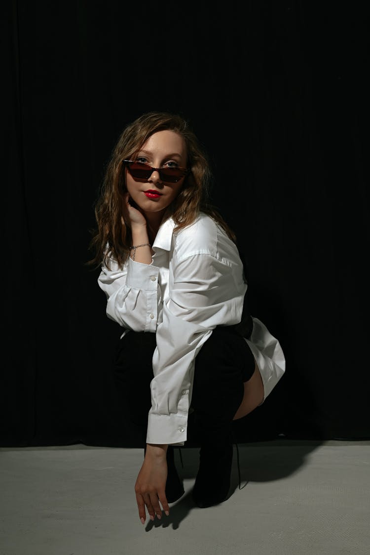 Fashion Woman in White Shirt And Black Boots Crouching