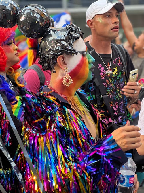 People in Colorful Costumes at Street Festival