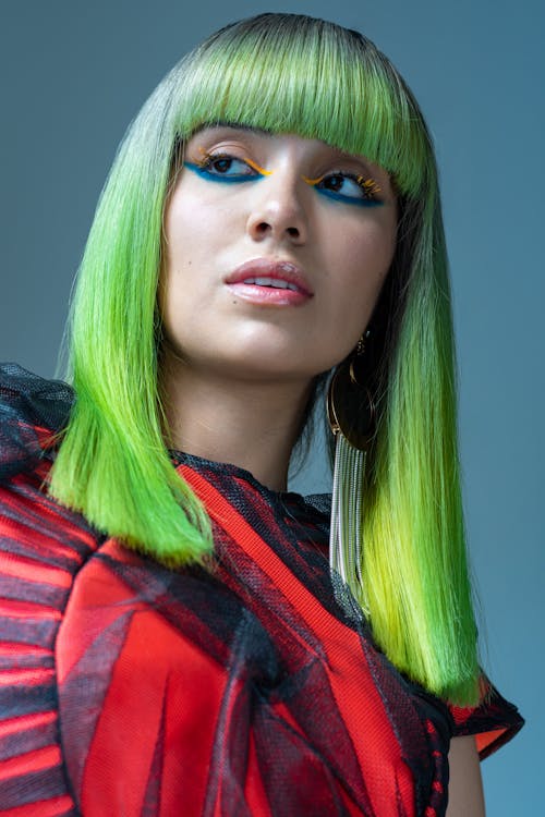 Young Woman with Long Green Hair and Creative Makeup