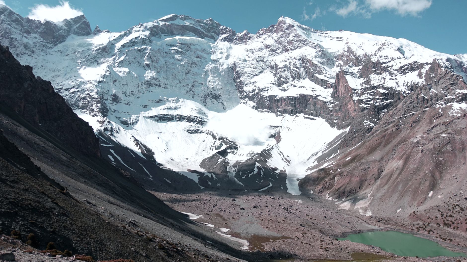 Stunning view of snow-capped mountains in Tajikistan, showcasing rugged glaciers and serene landscapes.