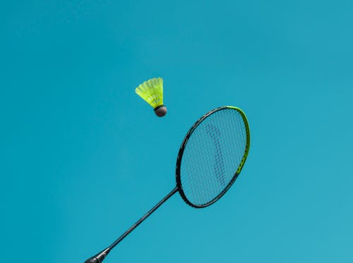 A Badminton Racket near a Shuttlecock