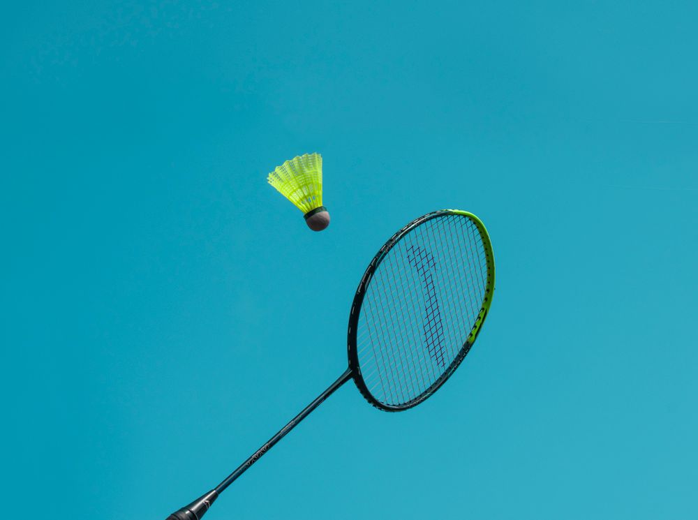 Shuttlecock in flight over a badminton net