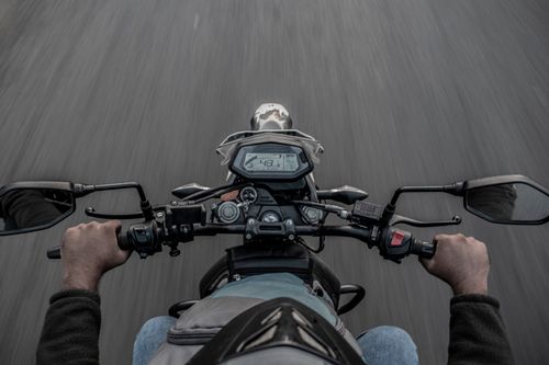 Free POV image of riding a motorcycle on a road, showcasing speed and adventure. Stock Photo
