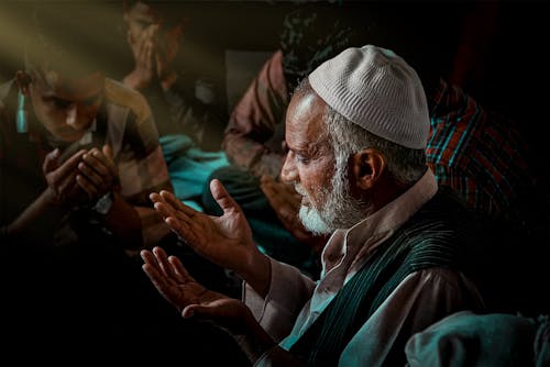 Free Men Spreading Their Hands in Prayer Stock Photo