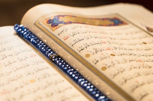 An Open Quran in Close-up Photography