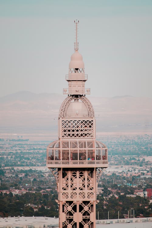 Close-up Photography of People Standing Inside Pink Tower