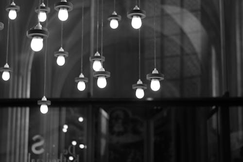 Grayscale Photography of Hanging Lights
