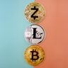 A gold Zcash coin positioned above Litecoin and Bitcoin tokens against a vibrant split blue and peach background.