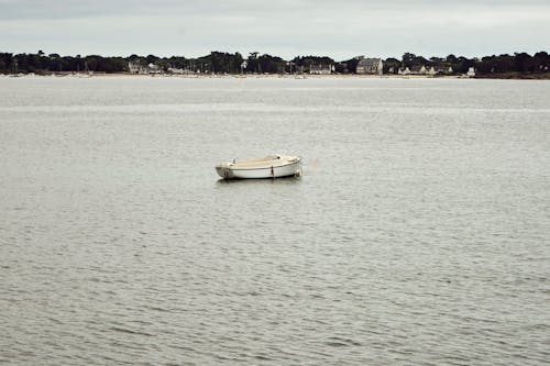 Free An Empty Boat in the Sea Stock Photo