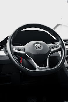 Close-up view of a Volkswagen car steering wheel focusing on modern design elements.