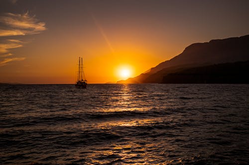 A Sailboat on the Sea during Sunset