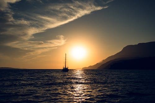 A Sailboat on the Ocean during Sunset