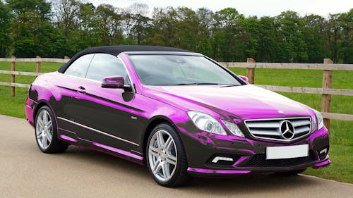 Purple Car Parked Near Wooden Fence