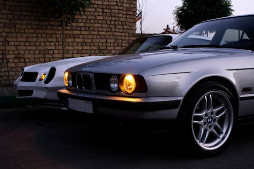 A Silver BMW Car with Park Lights On