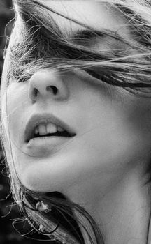 Artistic black and white close-up of a woman with windblown hair in Kyiv.