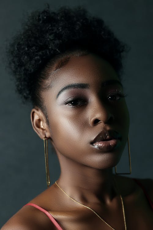 A Beautiful Woman Wearing Gold Necklace and Earrings