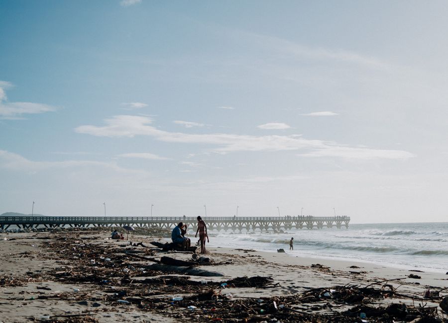 Scenic view of a beach with a dock at Puerto Colombia, ideal for travel enthusiasts.