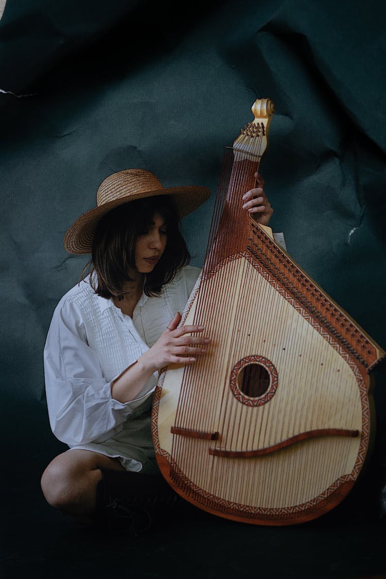 A Woman Playing A Bandura