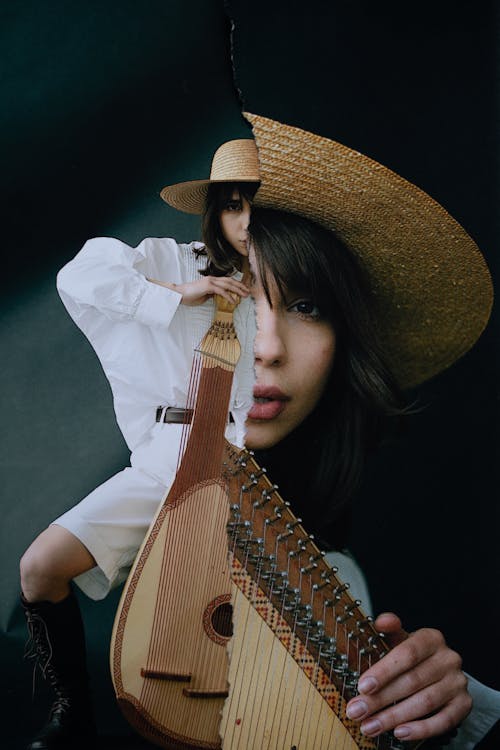 A Double Exposure Photograph of Woman in White Dress Shirt Holding Brown Musical Instrument
