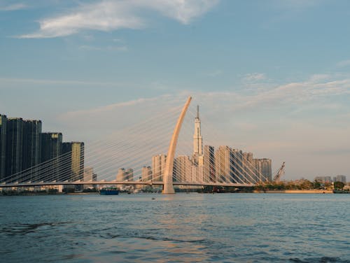 Bridge Over Body of Water Near City Buildings