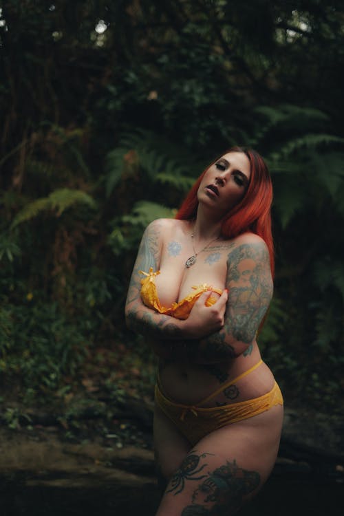 A Woman in Yellow Lingerie with Tattoos on Her Body