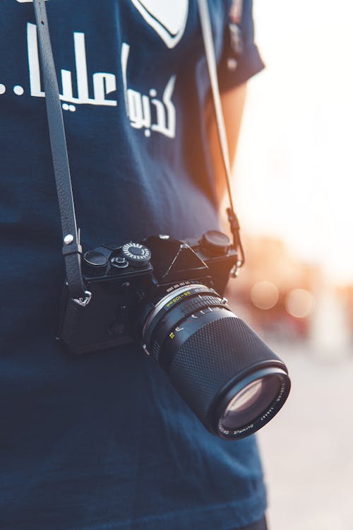 Free Close-up Photography of Person Wearing Black Camera Stock Photo