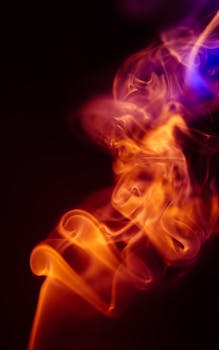 Captivating abstract fire and smoke against a dark background, perfect for creative designs.