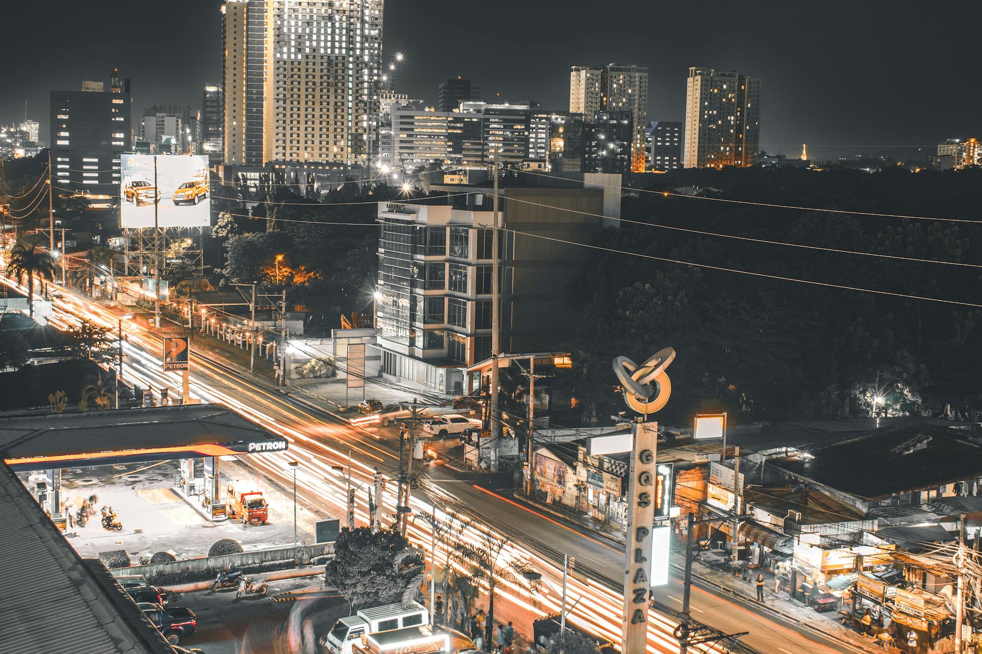 Dynamic cityscape view of Cebu City at night with bustling streets and high-rise buildings.