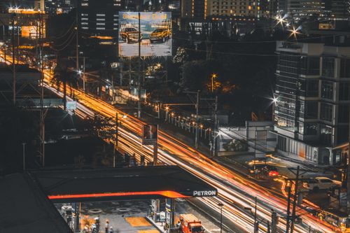 Free A dynamic long-exposure shot of Cebu City at night, highlighting the bustling urban life with illuminated streets and buildings. Stock Photo