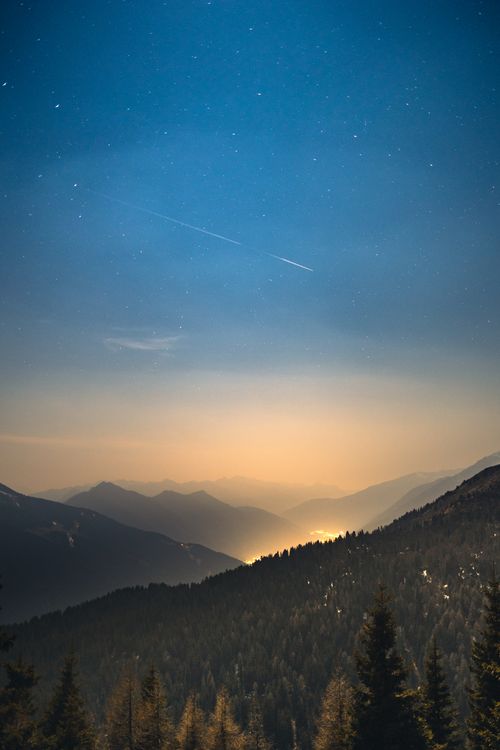 Free A breathtaking view of a starry night sky over Italian mountains, creating a serene landscape. Stock Photo