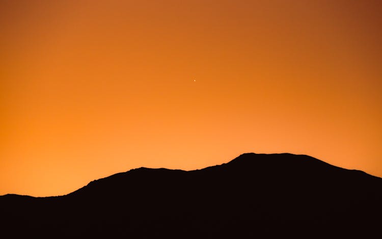 Silhouette Of Mountain During Sunset