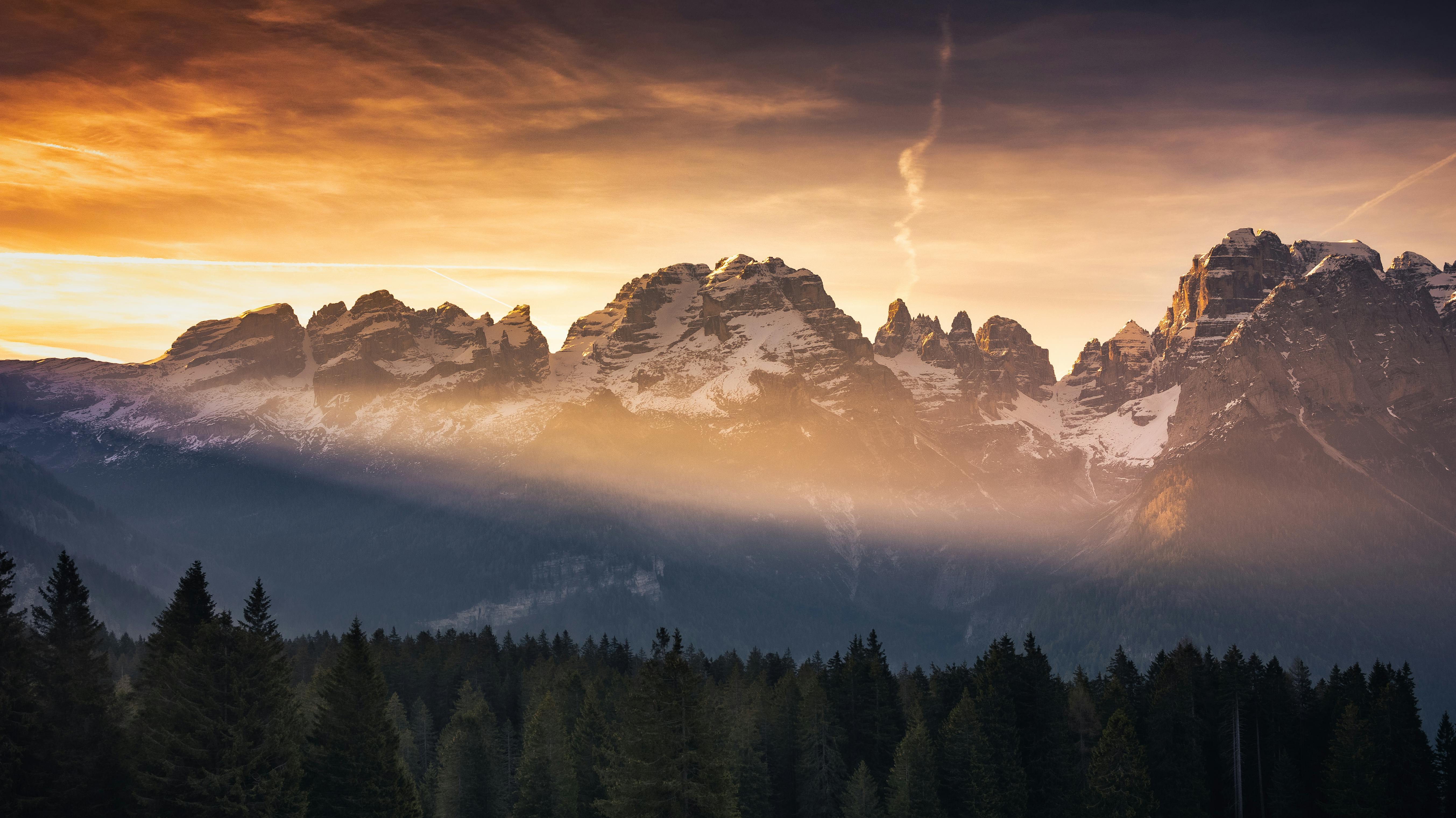 Stunning winter sunset over the Dolomites mountains, Italy, capturing serene beauty.