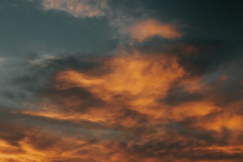 Free Stunning orange and dark clouds at sunset in Hungary, creating a dramatic sky scene. Stock Photo