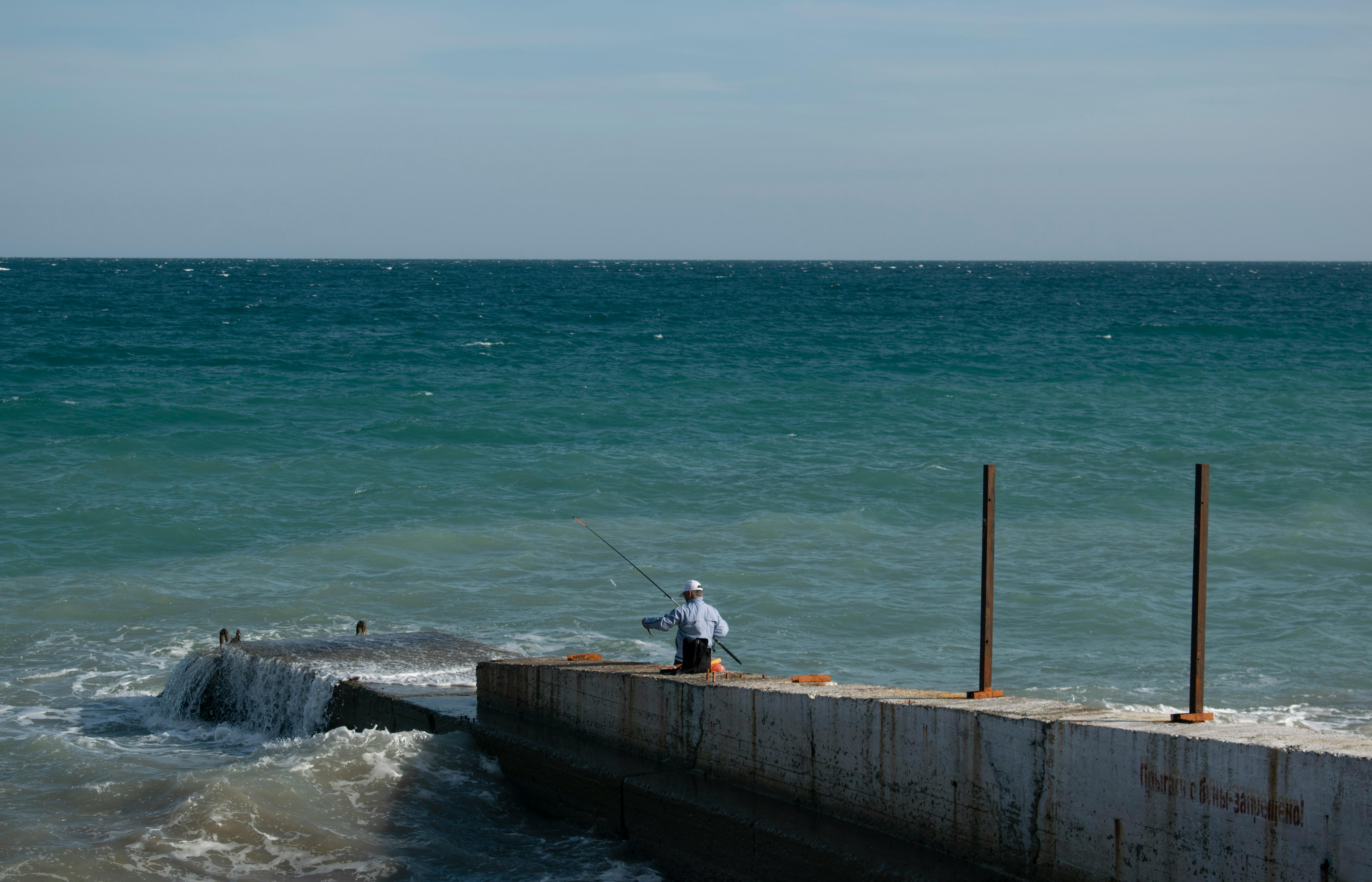 a man fishing on sea