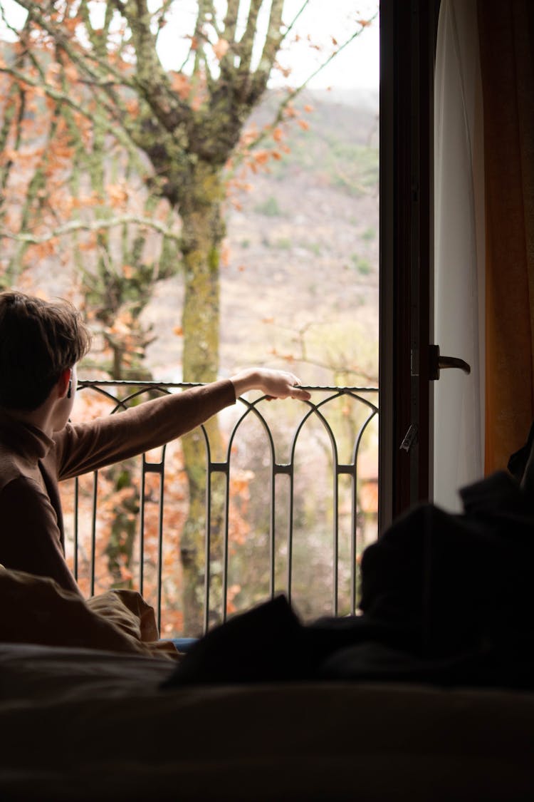 Man Looking Out Of Balcony